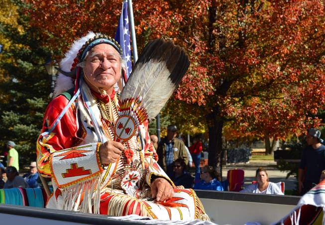 A man from the Agai Dicutta dancers of the Walker River Paiute Tribe in Shurz, Nev., rides in the annual Nevada Day parade in Carson City on Oct. 26, 2013.